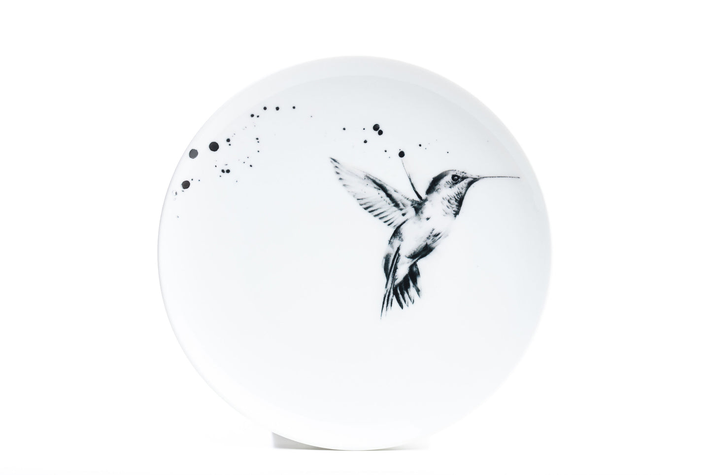 11" White coupe porcelain dinner plate with hummingbird in flight illustration and black ink splatter product photo on white background