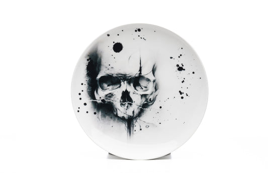 11" White porcelain skull dinner plate microwave and dishwasher safe with cool skull illustration and black ink splatter product photo on white background