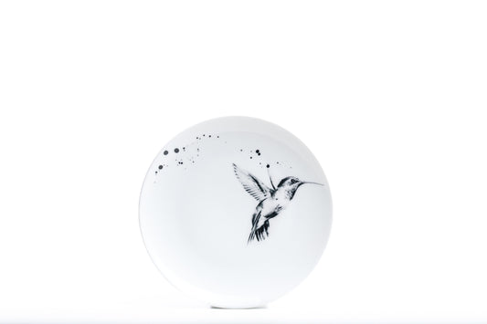 8" durable white coupe porcelain salad plate with hummingbird in flight illustration and black ink splatter dishwasher and microwave safe product photo on white background